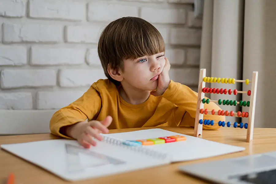 front-view-child-with-abacus-learning-from-laptop-home